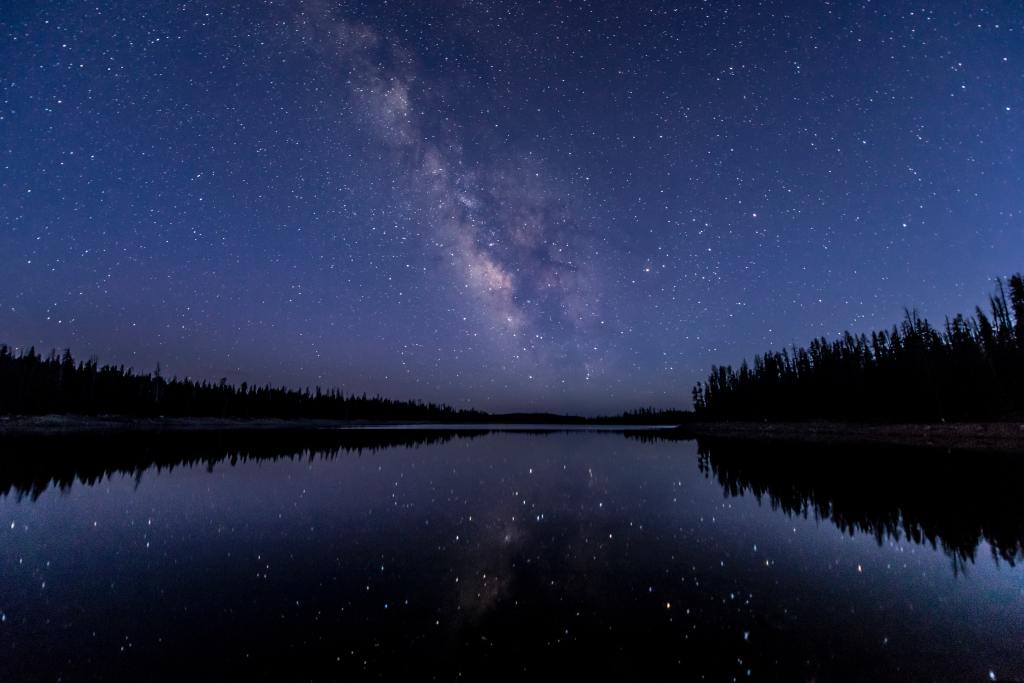 Night sky over a lake, photo by Jackson Hendry