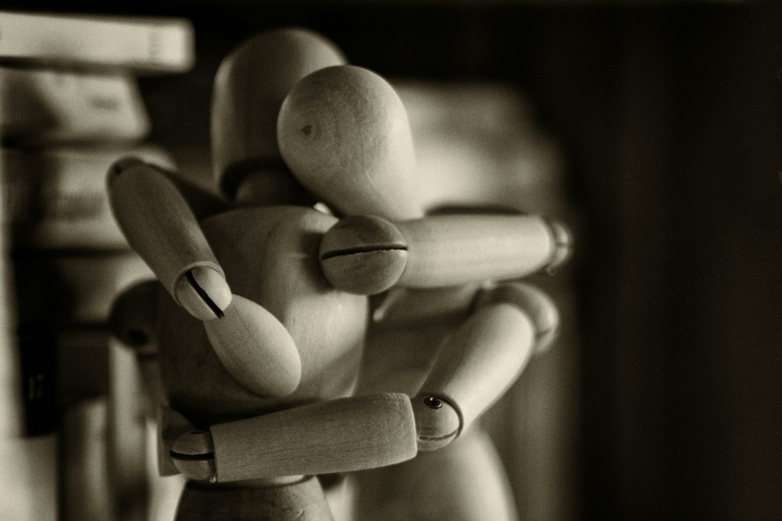 Two wooden figurines embracing
